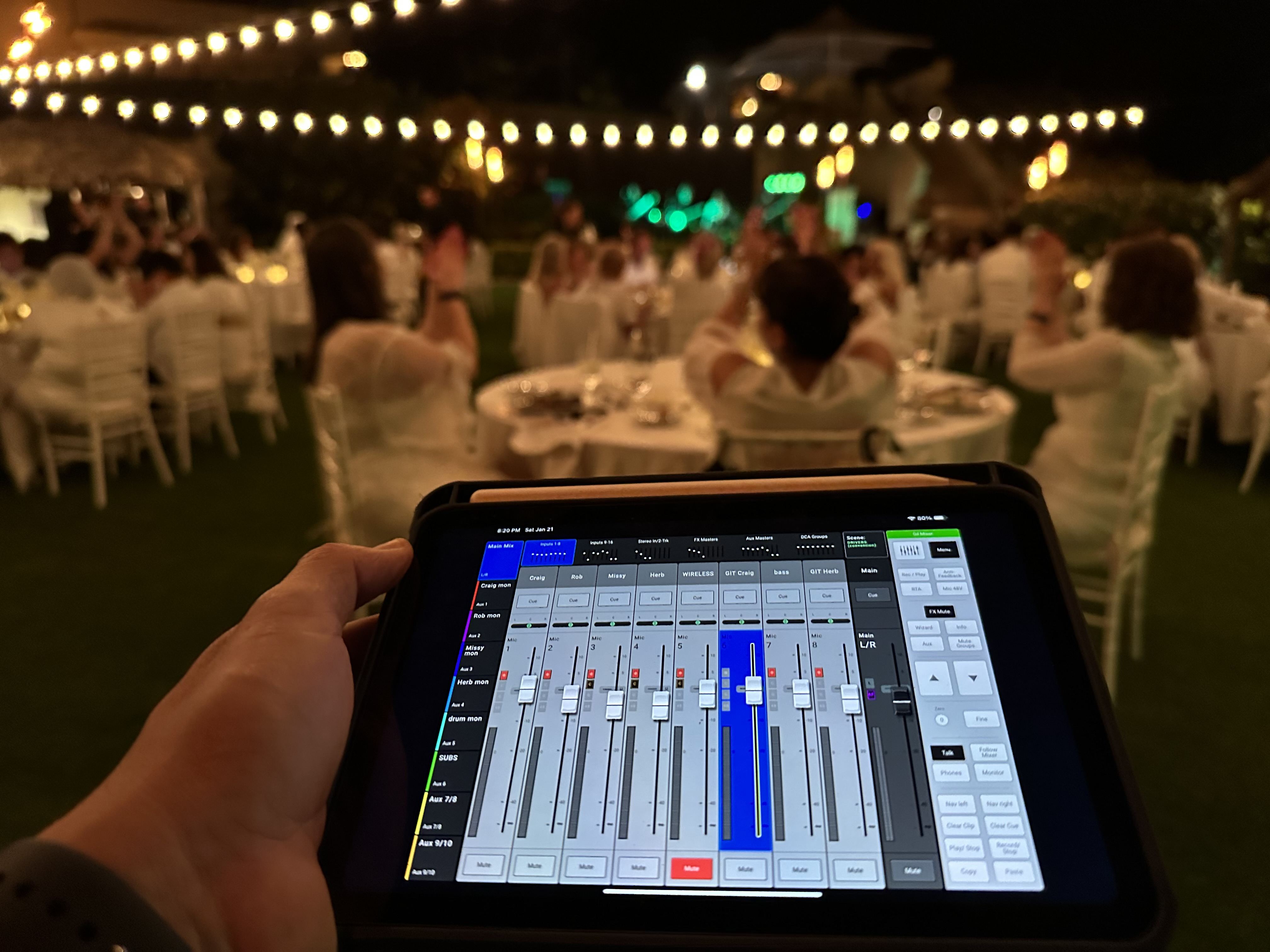 iPad displaying audio control software at a live sound station during concert setup